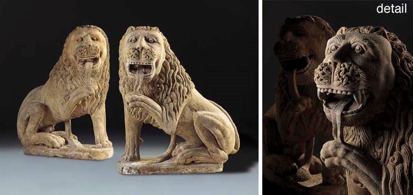 A PAIR OF CARVED SANDSTONE LIONS