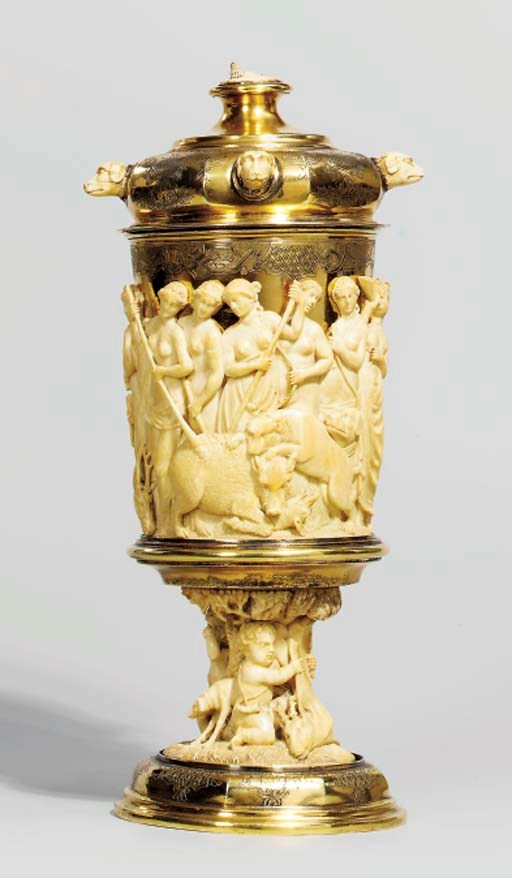 AN ENGRAVED SILVER-GILT AND CARVED IVORY CUP AND COVER