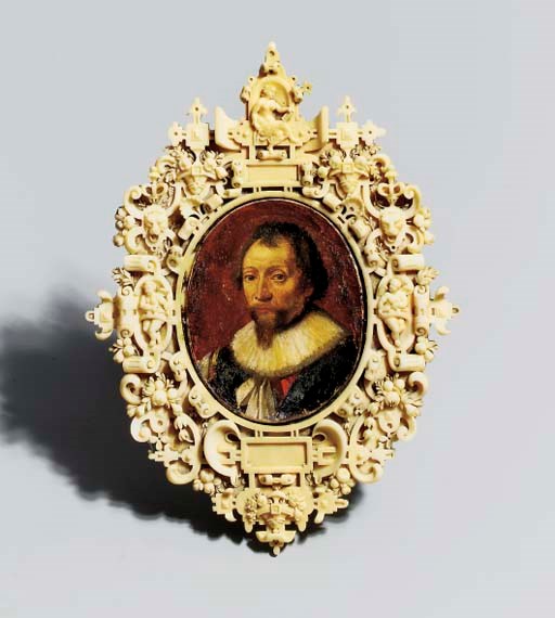 A CARVED IVORY FRAME WITH A PAINTED MINIATURE PORTRAIT OF A GENTLEMAN