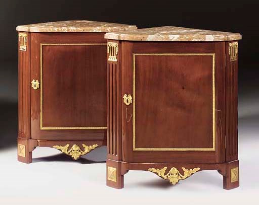 A PAIR OF LOUIS XVI ORMOLU-MOUNTED MAHOGANY ENCOIGNURES