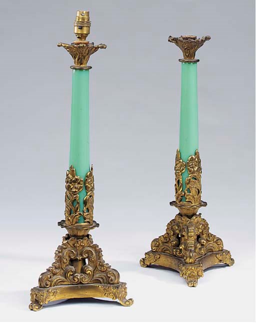 A pair of Victorian gilt bronze mounted green glass column table lamps