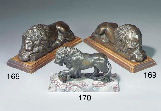 A pair of cast iron recumbent lions