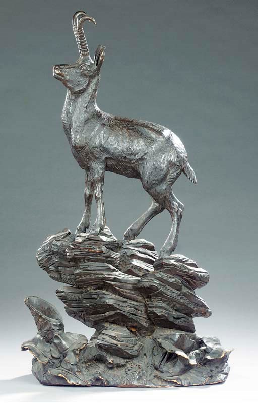 A Black Forest carved and stained wood model of a chamois