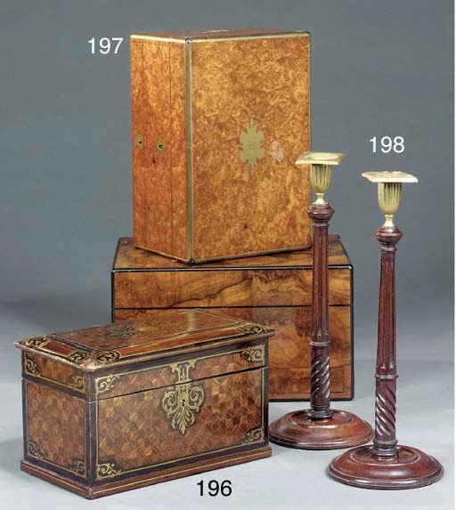 A pair of Edwardian mahogany and brass candlesticks
