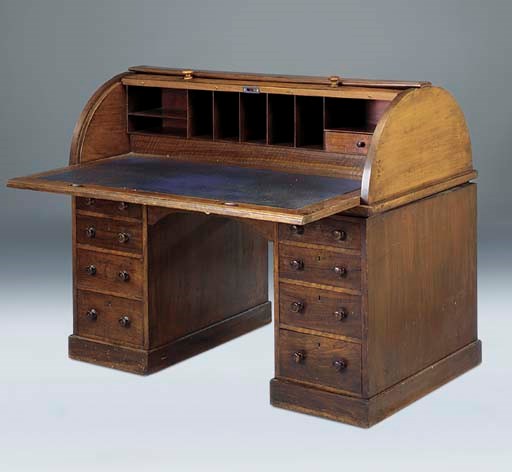 A late Victorian walnut roll top pedestal desk