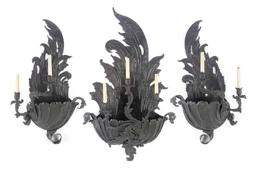 A SET OF THREE FRENCH BLACK-PAINTED REPOUSSE TOLE WALL-LIGHTS