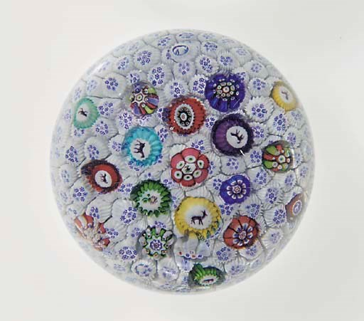 A Baccarat signed and dated blue and white carpet-ground scattered millefiori weight