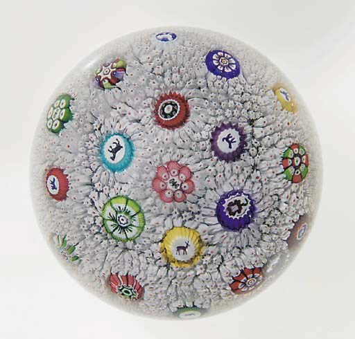 A Baccarat signed and dated white and pink carpet-ground scattered millefiori weight