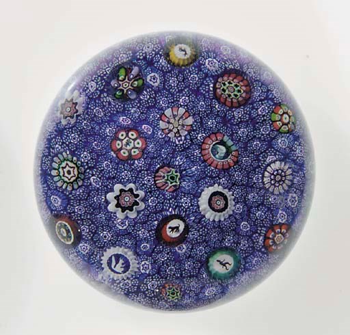 A Baccarat signed and dated blue carpet-ground scattered millefiori weight