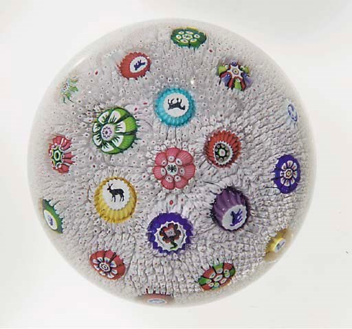 A Baccarat signed and dated scattered millefiori white and pink carpet-ground weight