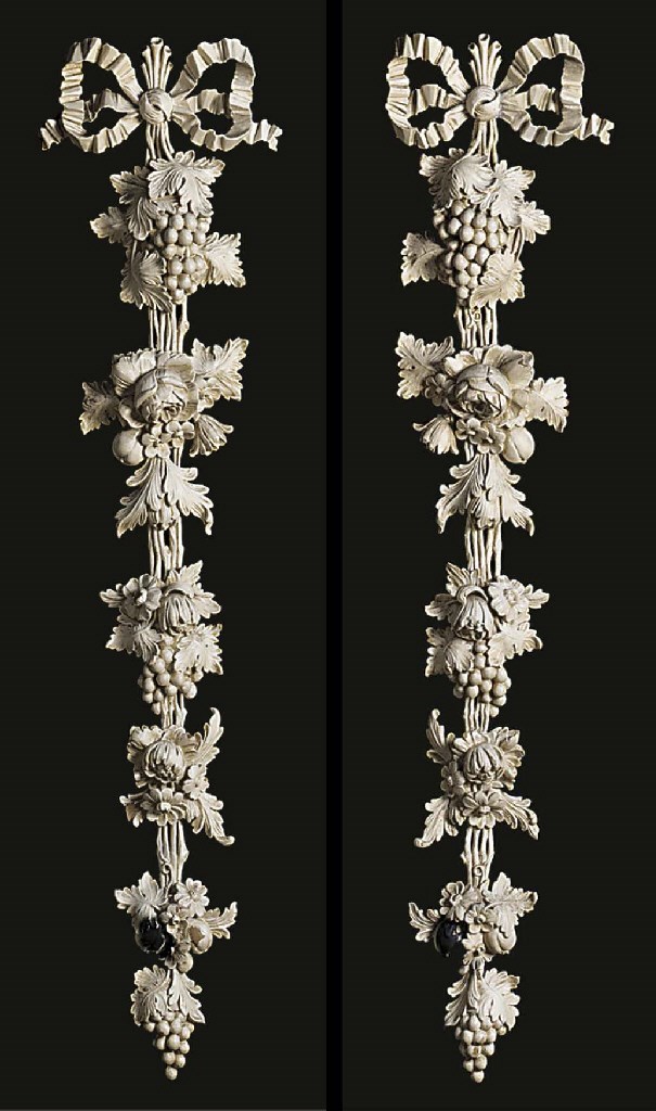 A pair of painted and carved pine wall appliques