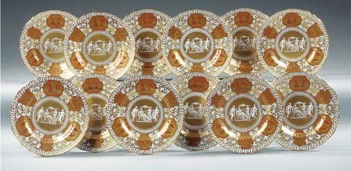 A set of twelve English painted and gilt heightened porcelain plates