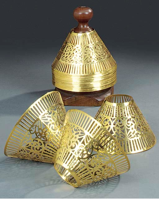 A set of twenty-four gilt white metal lamp shades