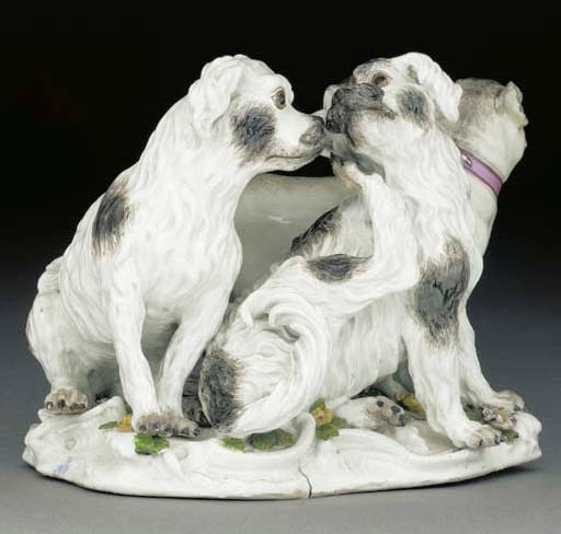 A Meissen group of two Bolognese terriers and a pug-dog