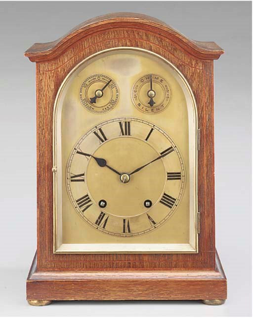 A mahogany and line inlaid quarter chiming mantel clock, first half 20th century