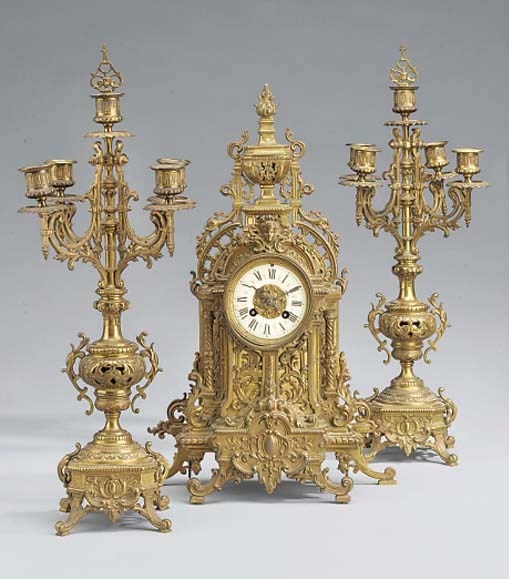 A French brass striking mantel clock and garniture, circa 1900