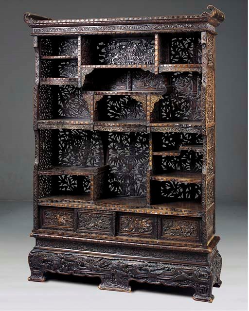 A CARVED AND STAINED SHADONA