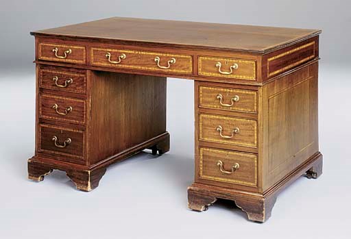 An Edwardian mahogany and satinwood crossbanded pedestal desk, by Druce and Co.