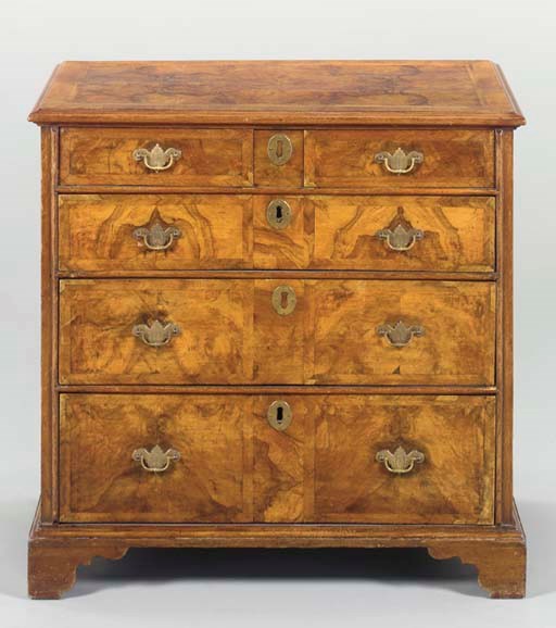AN ENGLISH BURR WALNUT AND OAK CHEST-OF-DRAWERS,