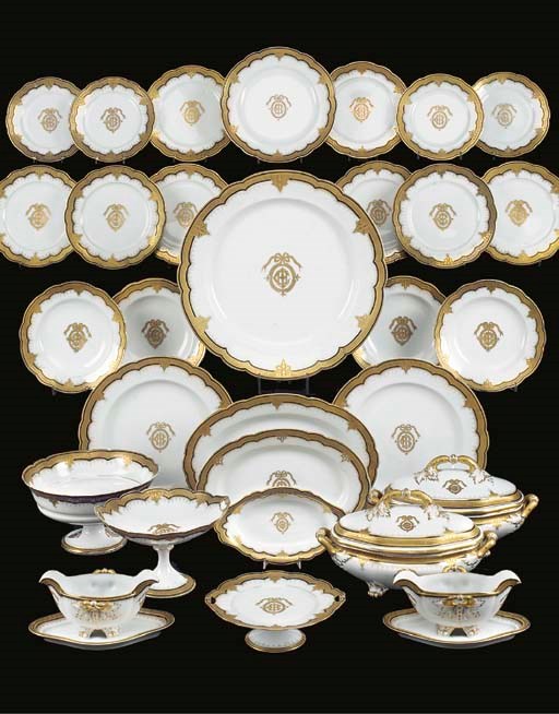 A parcel-gilt white porcelain monogramed dinner service