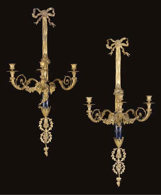 A PAIR OF LOUIS XVI STYLE ORMOLU AND BLUE DECORATED THREE BRANCH WALL-LIGHTS,