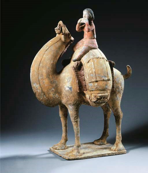 A painted grey pottery figure of a camel and rider