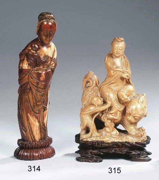 A red lacquer and gilt ivory figure of Guanyin