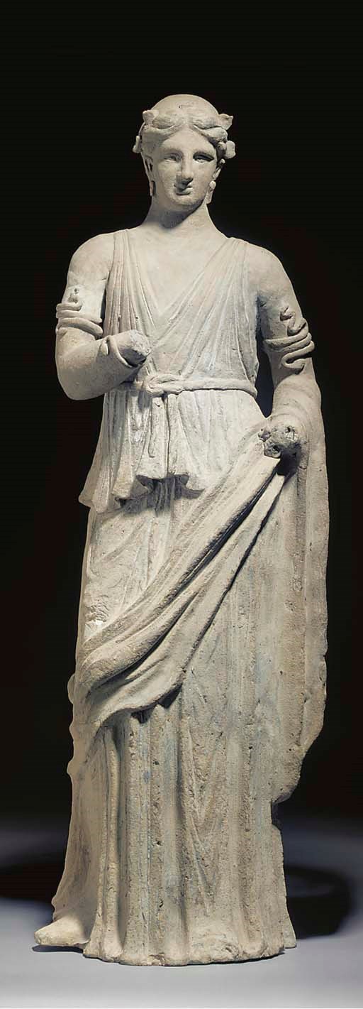 A LARGE ETRUSCAN TERRACOTTA FIGURE OF A YOUNG WOMAN