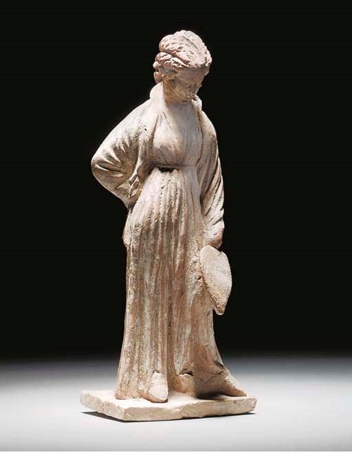 A TANAGRA STYLE TERRACOTTA FIGURE OF A WOMAN