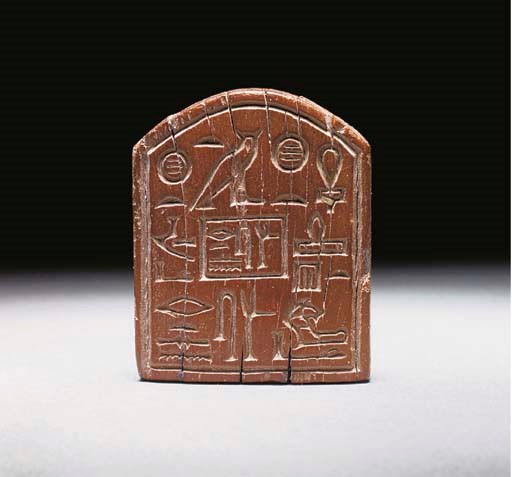 AN EGYPTIAN WOODEN STAMP SEAL OF THE MAYOR SENUSRET
