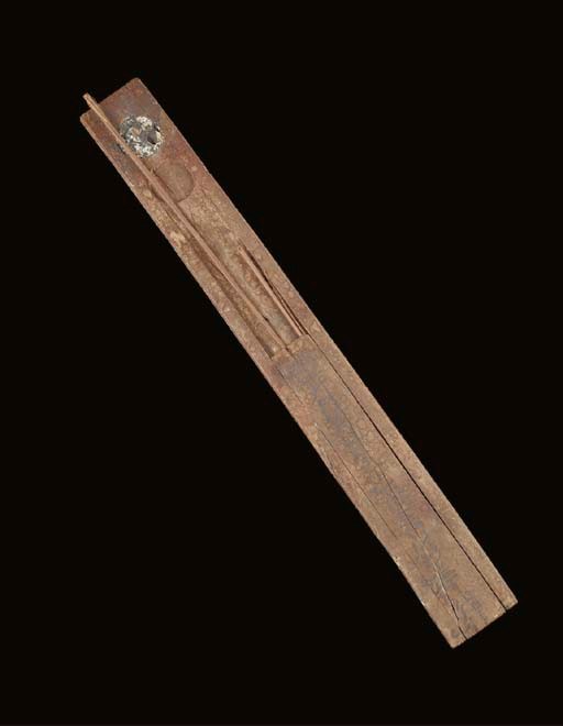 AN EGYPTIAN WOODEN SCRIBE'S PALETTE AND THREE REED PENS