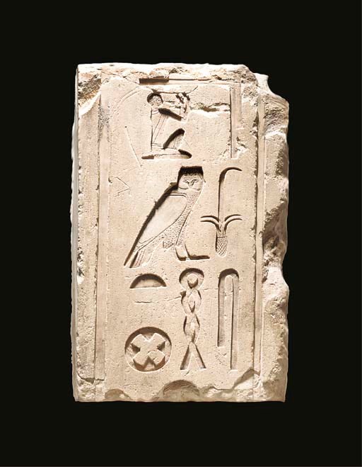 AN EGYPTIAN PAINTED LIMESTONE HIEROGLYPHIC RELIEF FRAGMENT