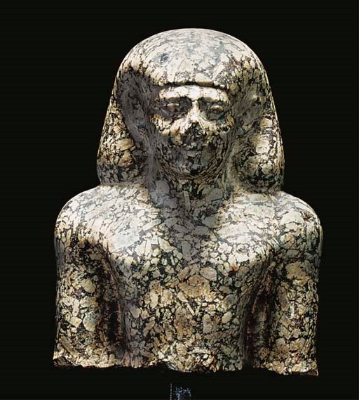 AN EGYPTIAN GREEN BRECCIA BUST OF A PRIEST OF KHONSU-PA-IR-SEKHER ('HE WHO PROVIDES')