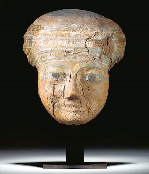 AN EGYPTIAN GESSO-PAINTED WOODEN ANTHROPOID MASK
