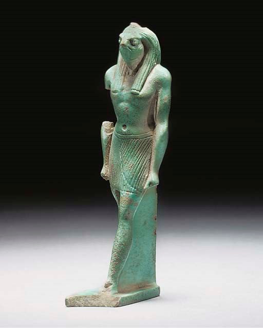 AN EGYPTIAN TURQUOISE GLAZED COMPOSITION STATUETTE OF HORUS