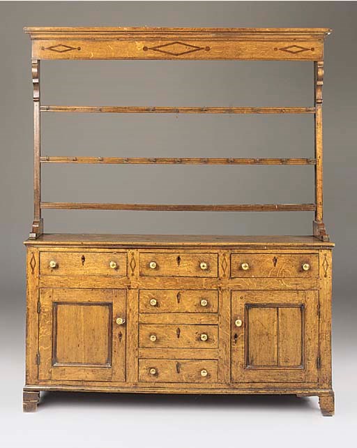 A CAERNARVONSHIRE OAK AND INLAID DRESSER