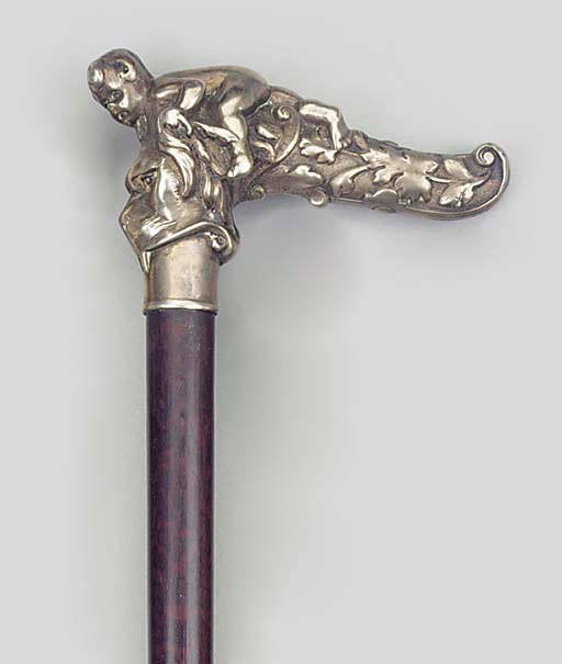 A CONTINENTAL SILVER MOUNTED SNAKE-WOOD WALKING STICK