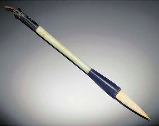 A mottled pale celadon jade and horn brush. 19th/20th century.