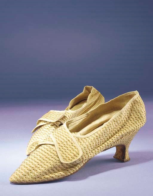 A pair of lady's shoes, of sand-coloured silk, brocaded with a brown and cream broken stripe, with narrow buckle straps, 2¾in. (7cm.) covered Italian heels, the toes with rounded point and with pointed tongue, circa 1770s