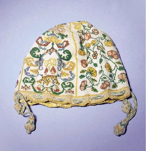 A drawstring purse, embroidered overall with coloured beads against a cream bead ground, divided into four panels, two with coronets above two hearts within a foliate cartouche, the other two panels with scrolling flowers swathed in ribbons, lined in lemon yellow silk, 17th century