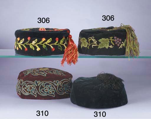 Three gentleman's smoking caps, two of black velvet embroidered with flowers and grapes, one of navy blue embroidered in yellow and blue with stylised Ottoman floral motifs, all with tassels, circa 1870s