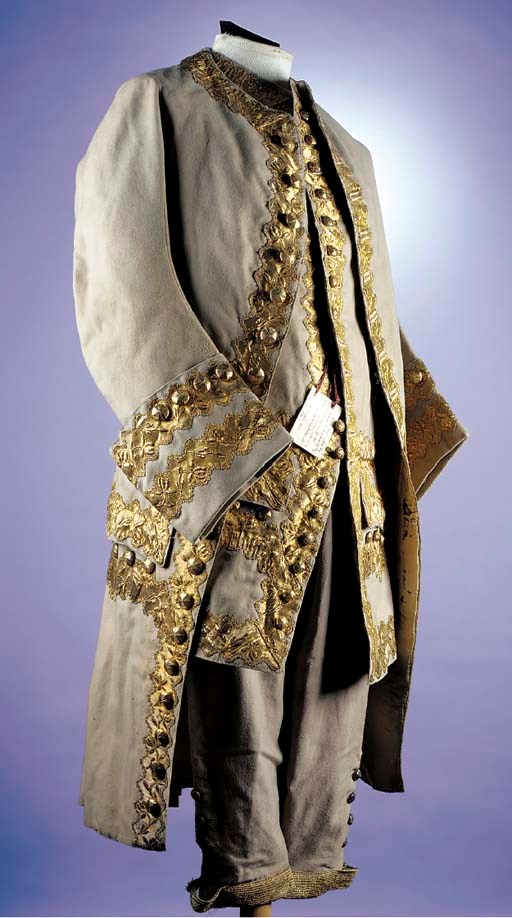 A gentleman's court suit, of mushroom facecloth, the coat, waistcoat and breeches trimmed with deep bands of gold braid, the buttons covered in gold foil, the coat lined in ivory silk