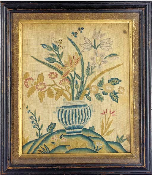 A tent stitched picture, worked in coloured silks with a vase of flowers on a hillocky ground from which sprout flowers and grasses, with a butterfly and insects hovering around--15 x 13¼in. (38 x 33.5cm.), framed and glazed, circa 1730s, two small dark stains to right ground