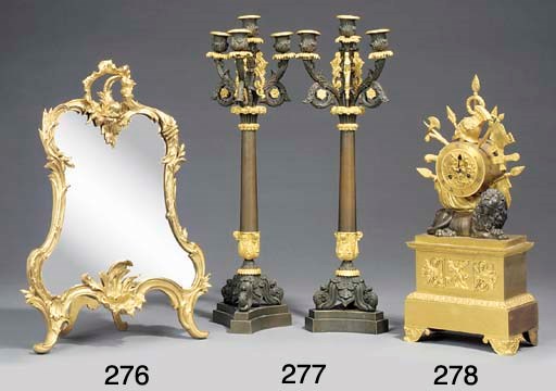 A pair of French gilt and patinated bronze four light candelabrum