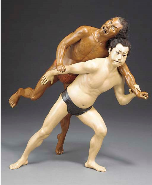 A Japanese polychrome carved wood group of two wrestlers