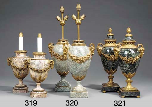 A pair of cippolino marble and gilt bronze ornamental urns