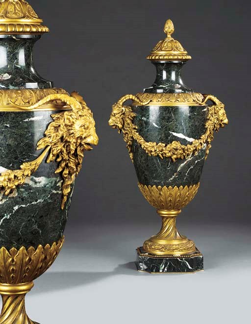 A pair of gilt bronze and verde antico marble ornamental urns and covers