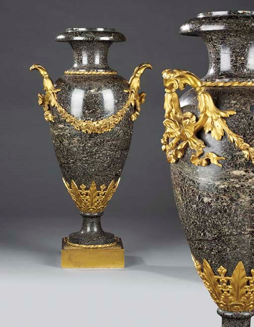 A pair of gilt bronze and rosso lavento marble ornamental urns