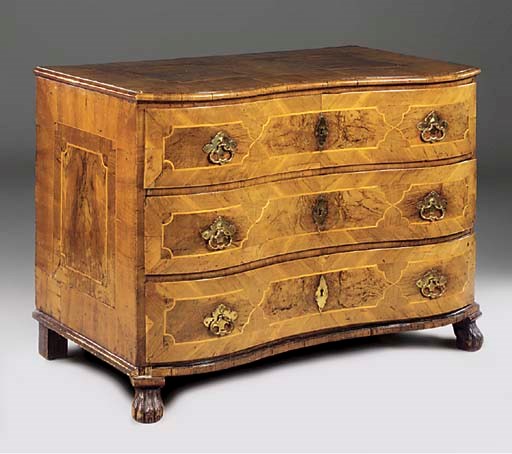 A SOUTH GERMAN WALNUT CROSSBANDED AND INLAID CHEST OF UNDULATING OUTLINE