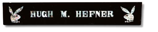 HEFNER, Hugh M. Nameplate used on his desk in Chicago, 1960s. Triangular black wood with enamel coating, with rabbit heads and name "Hugh M. Hefner" in mother-of-pearl, signed on back "Yougse Choi  Seoul Korea." Width 16 in. (40.5 cm.)